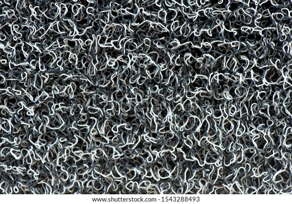 Close up of Vinyl dust trap carpet texture\
background. Abstract concept for pattern and design. Industrial\
gray and white vinyl carpet Coil Pattern Car Floor Mat texture.\
anti slippery surface
