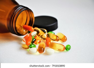 Close up vitamins and supplements on white background with a brown bottle. Including Vitamin c, vitamin E, vitamin D3, salmon oil, fish oil and co enzyme Q10 capsules. - Shutterstock ID 791810890