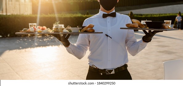 Close Up Waiter Holding Plates With Appetizer In The Restaurant. 