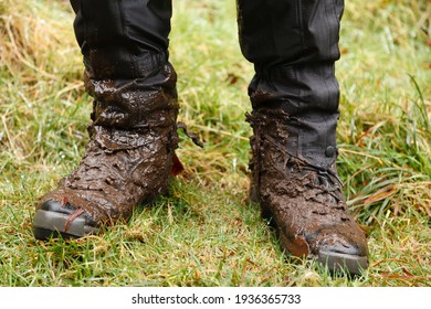 Close Up Of Walking Boots. Man, Male Hiker Wearing Muddy Hiking Boots And Waterproof Gaiters In Wales, UK