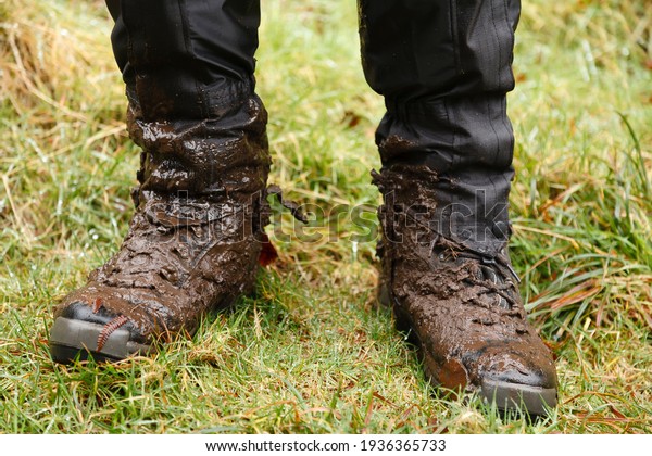 Close up of walking\
boots. Man, male hiker wearing muddy hiking boots and waterproof\
gaiters in Wales, UK