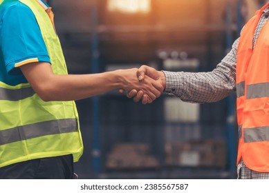 Close up warehouse worker shakehand together. Engineer man hands partnership. Diversity Coworker Men logistics Warehouse teams handshake. Multiracial Support team greeting person teamwork colleagues - Powered by Shutterstock