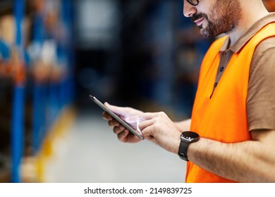 Close up of a warehouse worker using tablet.