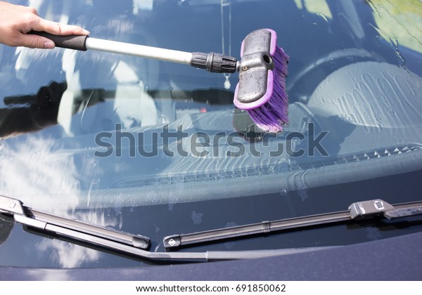 Close up washing the car with brush outdoor . Car\
cleaning concept related