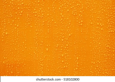 Close Up Water Drop On Orange Background.