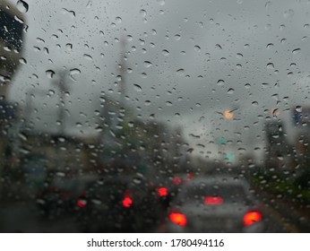 Close Up Water Droplet  On Windscreen And Blured Background Car In Trafic Jam 