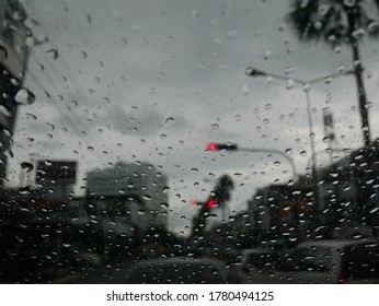 Close Up Water Droplet  On Windscreen And Blured Background Car In Trafic Jam 