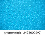 Close up of water droplets on blue background.