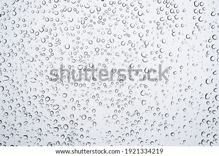 Close up Water Drops on window Glass on a autumn rainy day. rain Wet weather  Background