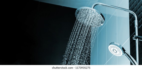 Close up of Water flowing from shower in the bathroom interior - Shutterstock ID 1173935275