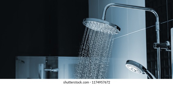 Close up of Water flowing from shower in the bathroom interior - Shutterstock ID 1174957672