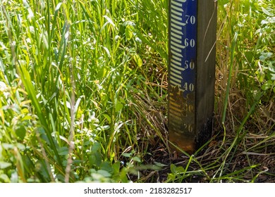 Close Up Of Water Level Depth Meter, Staff Gauge In The River. Extreme Low Water. Global Warming. Shortage Or Lack Of Water Due To Hot Temperatures. New Climate. Crisis, Part Of A Serie.