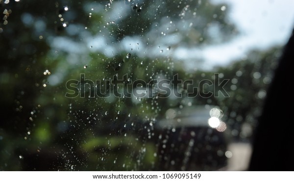 Close up water splashed on car\'s window and it\
became to drops\
background