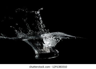 close up of water waves splash and bubbles isolated on black background.