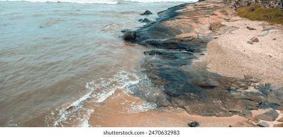 Close up of waves slapping rock in beach