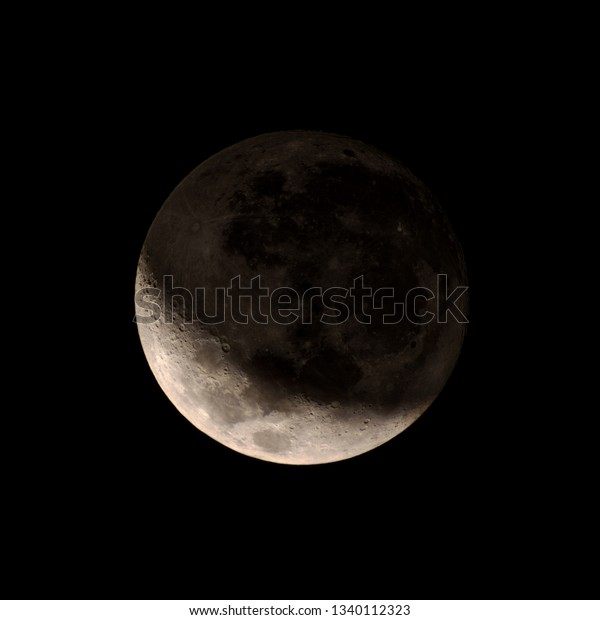Close up Waxing Crescent Moon phase with detail in\
shadow on dark sky