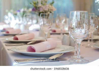 Close Up Of Wedding Dinning Table Set Up With White Round Plates And Pink Napkins