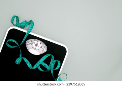Close up Weight scale and measure tape with copy space , Weight loss or healthy diet control to slim healthy body concept - Shutterstock ID 2197512085