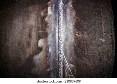 The close up weld on a steel pipes for a new heat line.