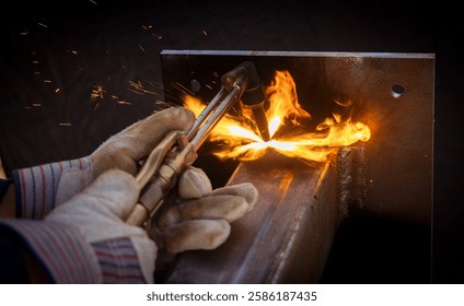 Close up of a welding torch emitting fire and sparks on a metal beam  - Powered by Shutterstock - Get 15% off with code: PIKWIZARD15