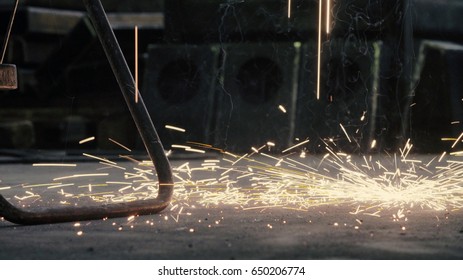 Close Up Of Welding's Sparks Falling On The Floor