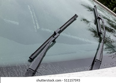 Close Up Of Wet Windshield Reflections Patterns Textures And Wiper Blades And Arms 