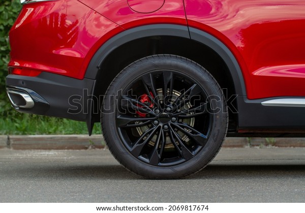 A close up of wheel disk and the side of car. Car\
wheel on a car.