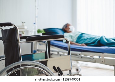 close up wheelchair over disabled old patient with mask at hospital - Powered by Shutterstock