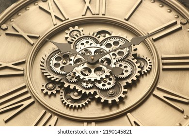 Close Up Of Wheels And Hands Of Metal Wall Clock With Roman Numerals