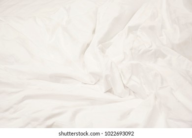 Close up of white bedding sheets and copy space.