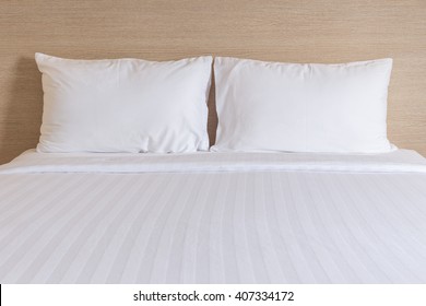 Close Up White Bedding Sheets And Pillow In Hotel Room