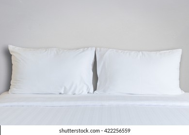 Close Up White Bedding Sheets And Pillow In Hotel Room