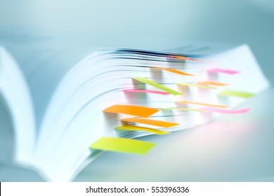 Close up White book marked by sticky note - Shutterstock ID 553396336