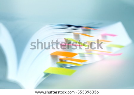 Close up White book marked by sticky note