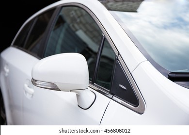 close up of white car rear view mirror