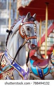 Close up of a white Carousel Horse Head with a Colorful Bridle, on Blurred background. Horizontal Image.