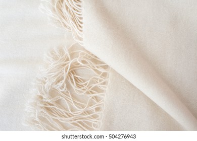 close up of white cashmere wool - fashion background - tassels detail