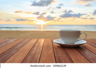 Close Up White Coffee Cup On Wood Table And View Of Sunset Or Sunrise Background 