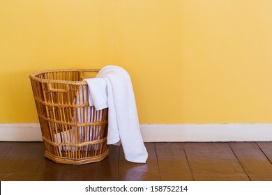 Close up white color used towels in wicker basket