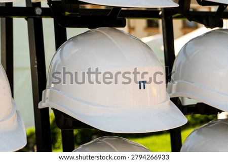 Close Up of White Construction Hard Hat Inscribed with IT Profession Text.