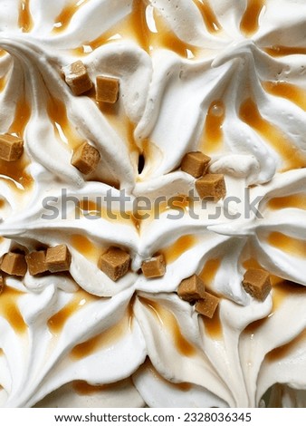 Close Up of White Creamy Ice Cream With Brown Caramel Topping And Orange Pieces of Caramel Square Particles With Copy Space For Text Overlay, Summer Frozen Treats for Refreshment, Unhealthy Eating