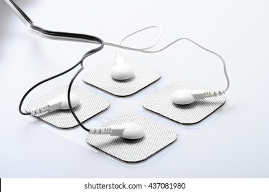 Close up of white electrodes and electrical stimulation device