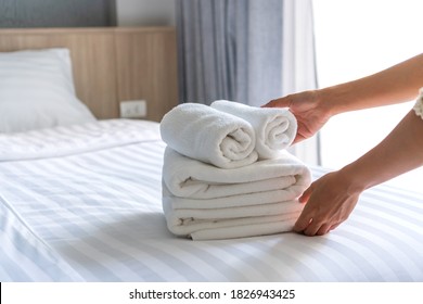 Close Up Of White Hotel Bed Sheets And Towel Set , Maid Cleaning Bed. Room Service. Hotel Business Concept.