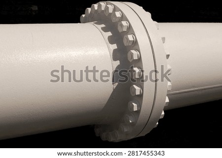Close up of white industrial pipe flange with bolts