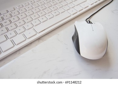 Close Up of White Keyboard and Mouse (Data Entry Equipment) on The White Table