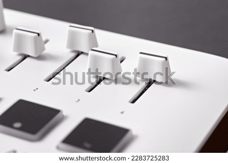Close up white midi keyboard. Midi controller faders