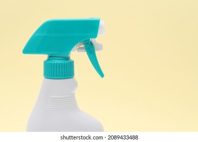 Close Up Of White Plastic Bottle With Spray And Foam Nozzle On Yellow Background  