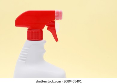 Close Up Of White Plastic Bottle With Spray And Foam Nozzle On Yellow Background  