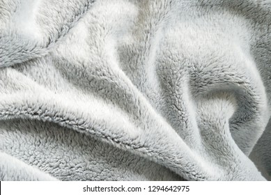 Close up white shaggy artificial fur texture or carpet for background