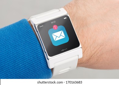 Close up white smart watch with unread message icon on the screen is on hand - Powered by Shutterstock